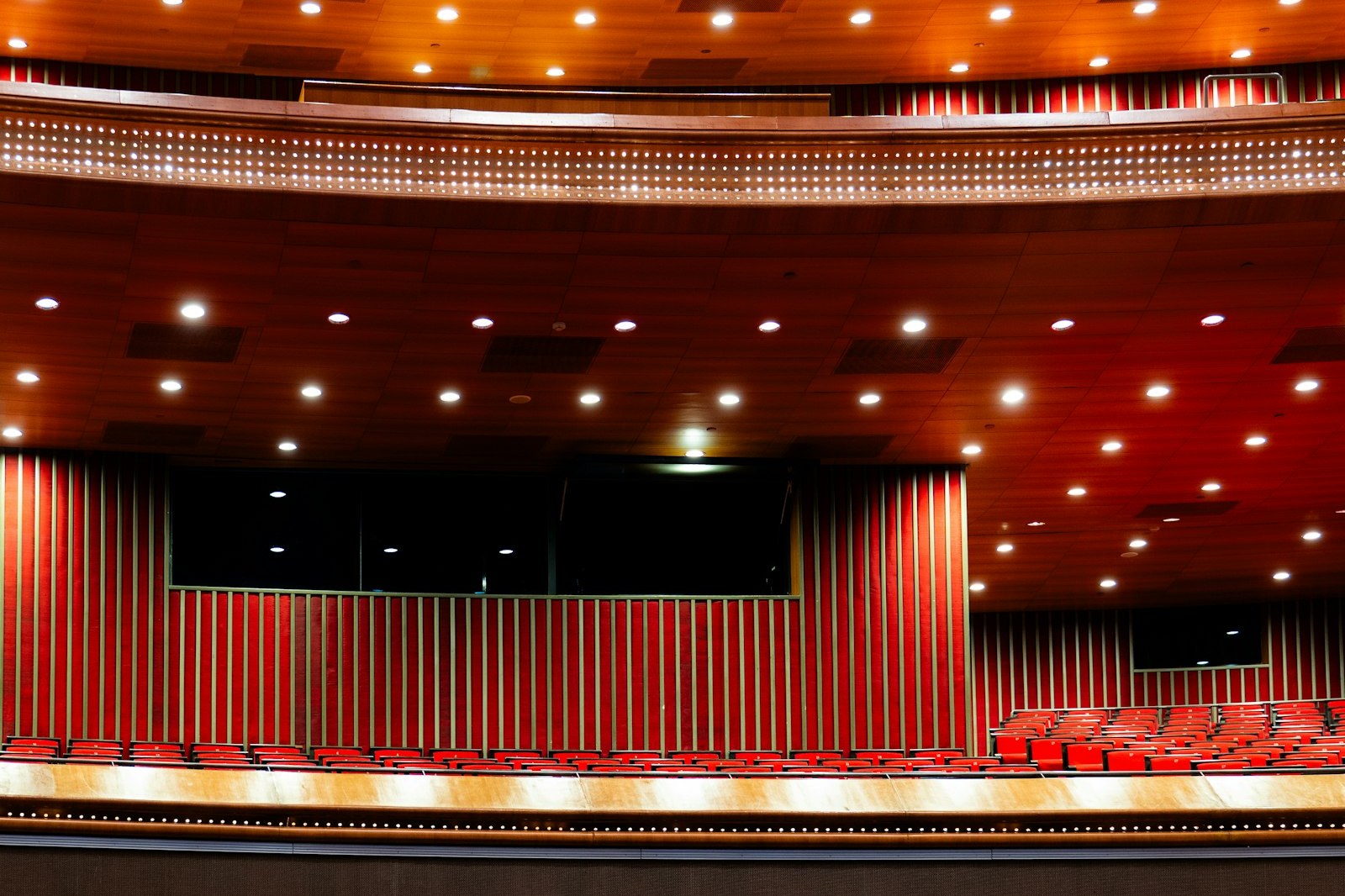 Empty red seats and a stage in a large church auditorium