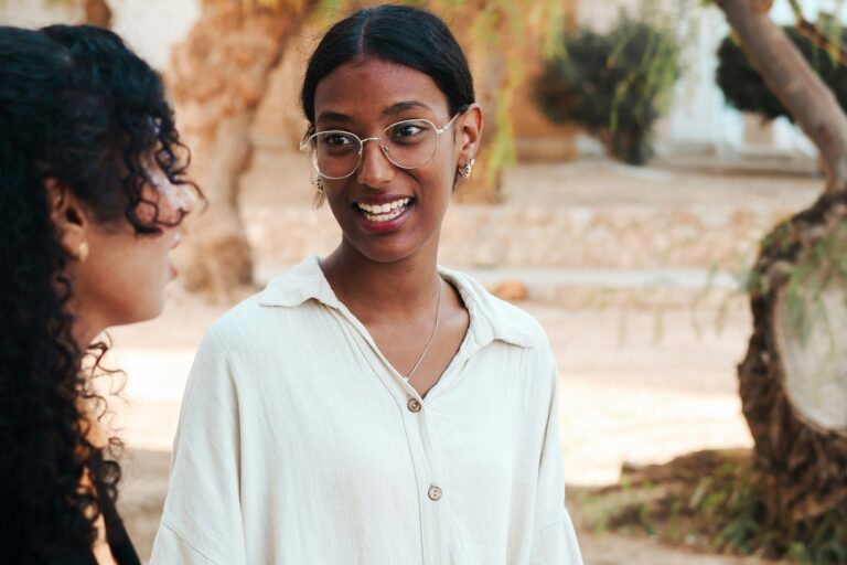 Two women having a warm, open conversation outdoors
