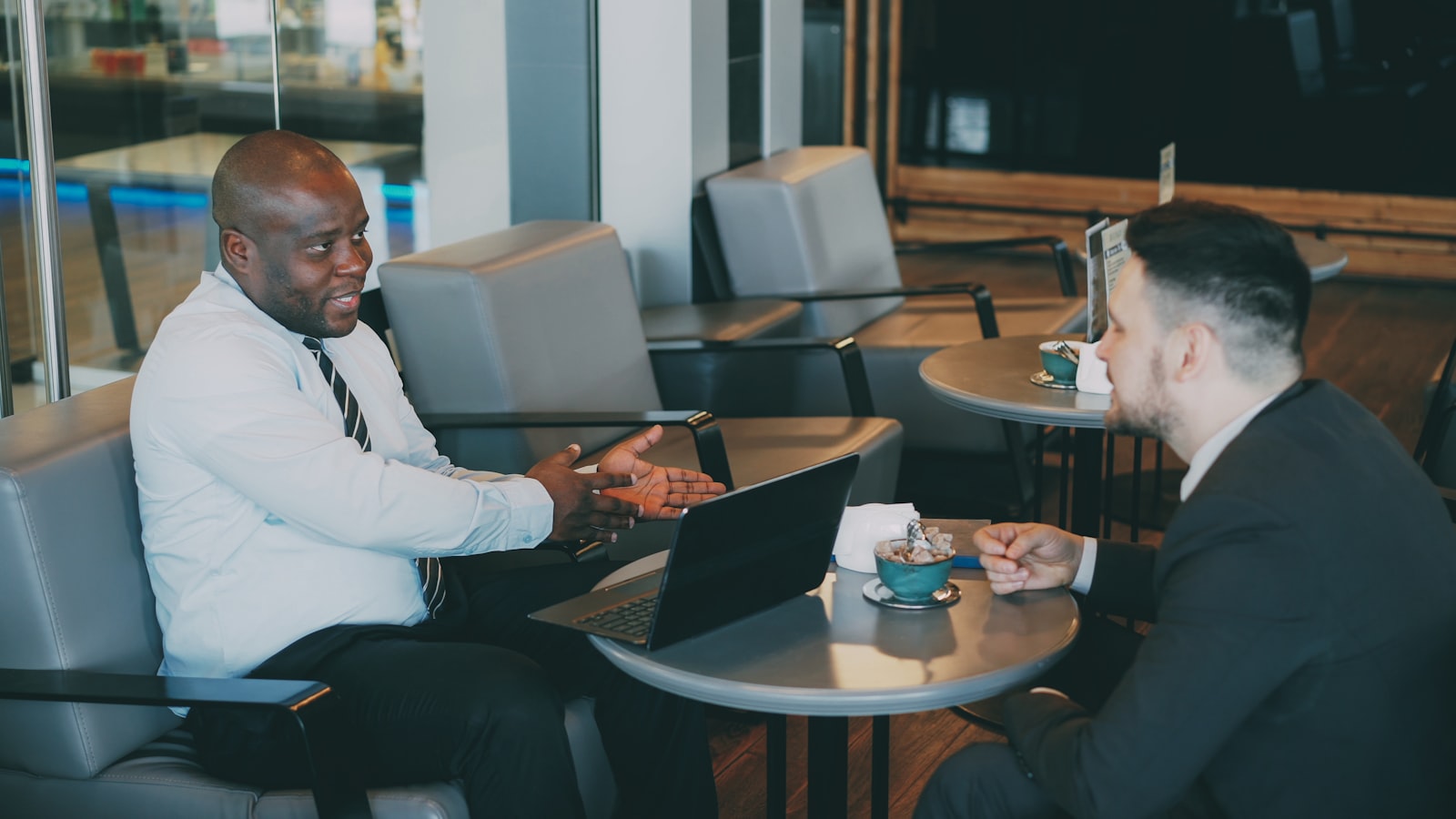 Two people in a serious conversation at a table